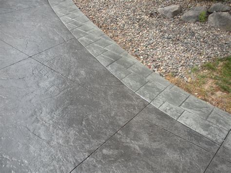 black stamped concrete driveway