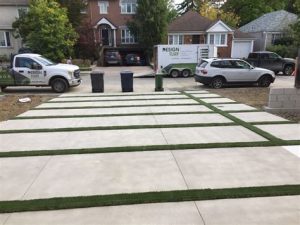 concrete driveway with grass strips