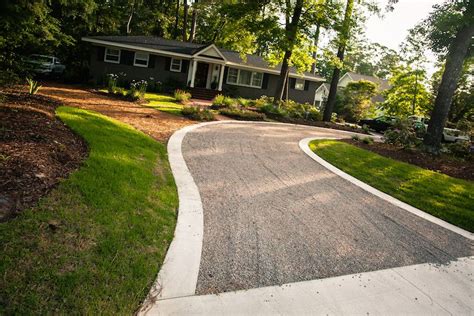 concrete driveway with river rock